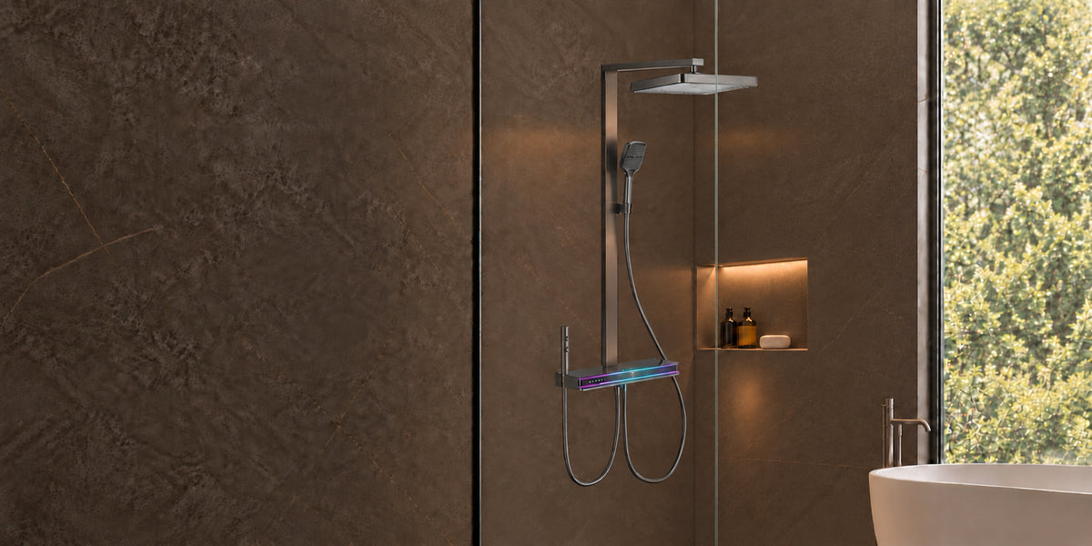 Rivo Viva Spa shower system in Ashen Grey, featuring an overhead rain shower, handheld shower and illuminated Shower Platform against dark stone bathroom walls.